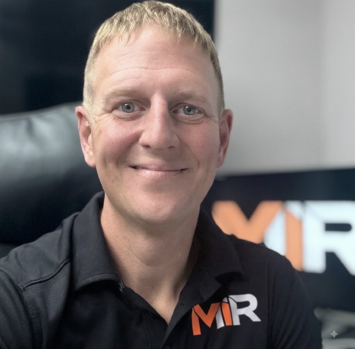 Andrew Hawes, Founder of MIR, wearing a black MIR-branded polo shirt